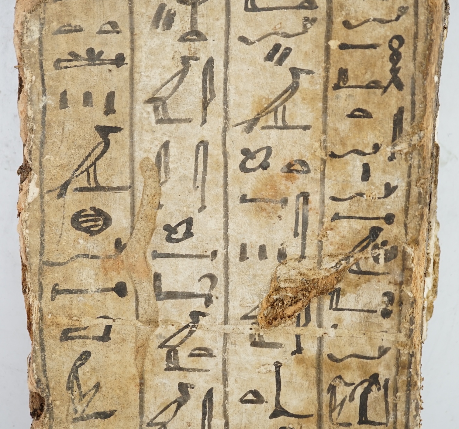 An Ancient Egyptian painted gesso, linen and wood fragment from a coffin or canopic chest, probably late Kingdom